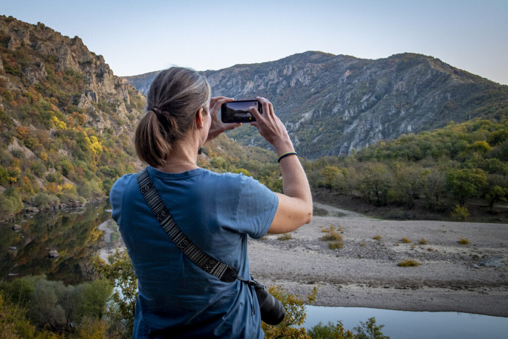 Laurien Holtjer taking a picture of Arda river in the Rhodope Mountains at sunset, Communications Gathering 2024.